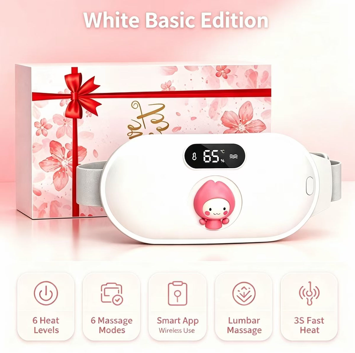 White basic edition wireless lumbar massage device shown in front of its pink floral gift box with a red ribbon. The device has a digital temperature display showing 65 degrees Celsius and a cartoon character on the front.