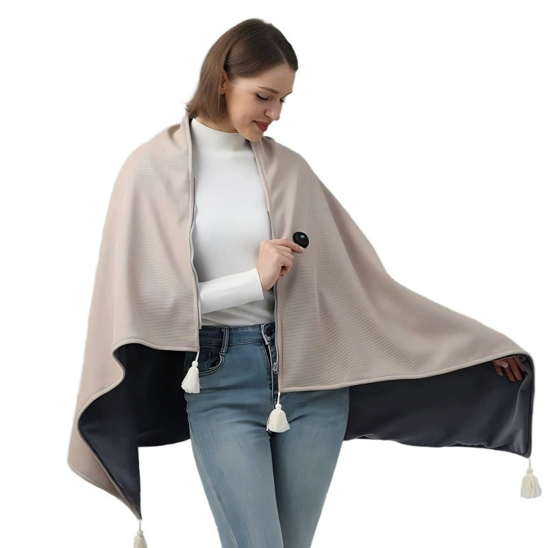 A woman modeling a zippered shawl wrap with a beige exterior and a black interior, shown against a plain white background.