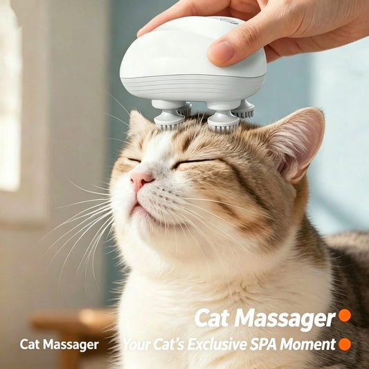 A white handheld cat massager being used on a closed cat head, with a human hand holding the device. The cat has brown and white tabby fur, and the background is a softly blurred indoor setting.
