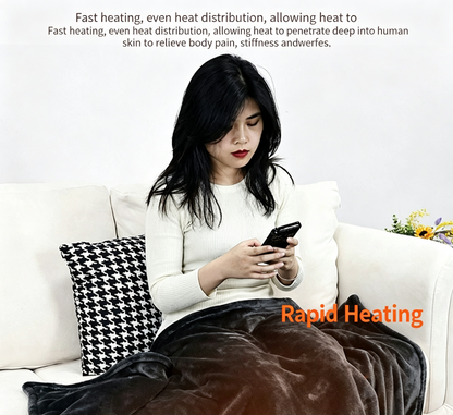 A woman sits on a white sofa using her phone while wrapped in a dark brown plush blanket. Text overlays describe the blanket's fast heating and even heat distribution benefits, with 'Rapid Heating' written in orange.
