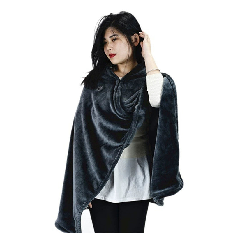 Woman wearing a dark gray poncho with a logo on a white background